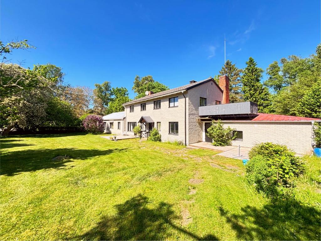 a house with a large yard in front of it at B&B Villa Vila in Löttorp