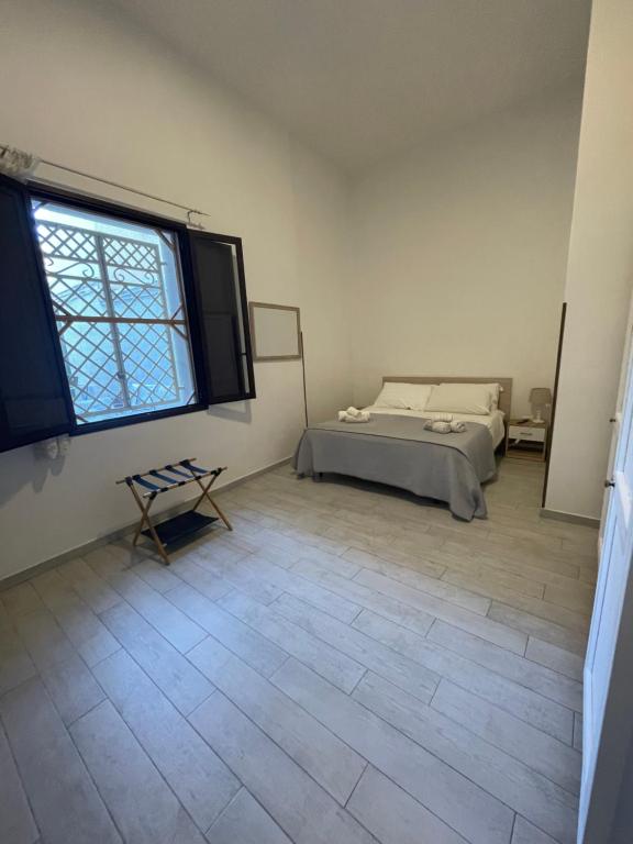 a bedroom with a bed and a large window at Marsala al centro n9 in Marsala