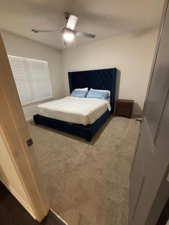 a bedroom with a bed and a ceiling fan at King Blue Oasis in Madison