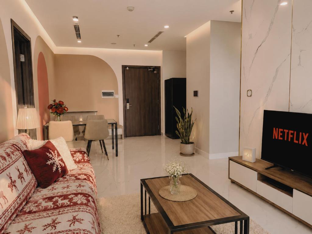a living room with a couch and a tv at Oliver's vacation home - Vinhomes Grand Park in Long Bình