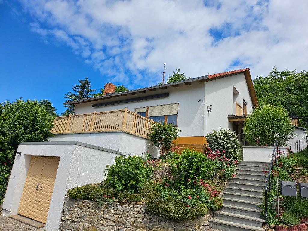 a white house with a balcony on top of it at T&G WirthHaus in Bad Rappenau