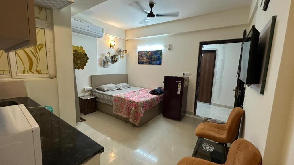 a small room with a bed and a tv in it at THE NEST - Kingdom in Ghaziabad