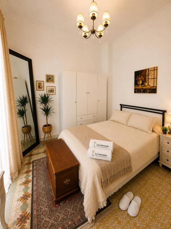 a bedroom with a large bed and a chandelier at Van Gogh Luxury Flat By CH Luxury Apartments in Alicante