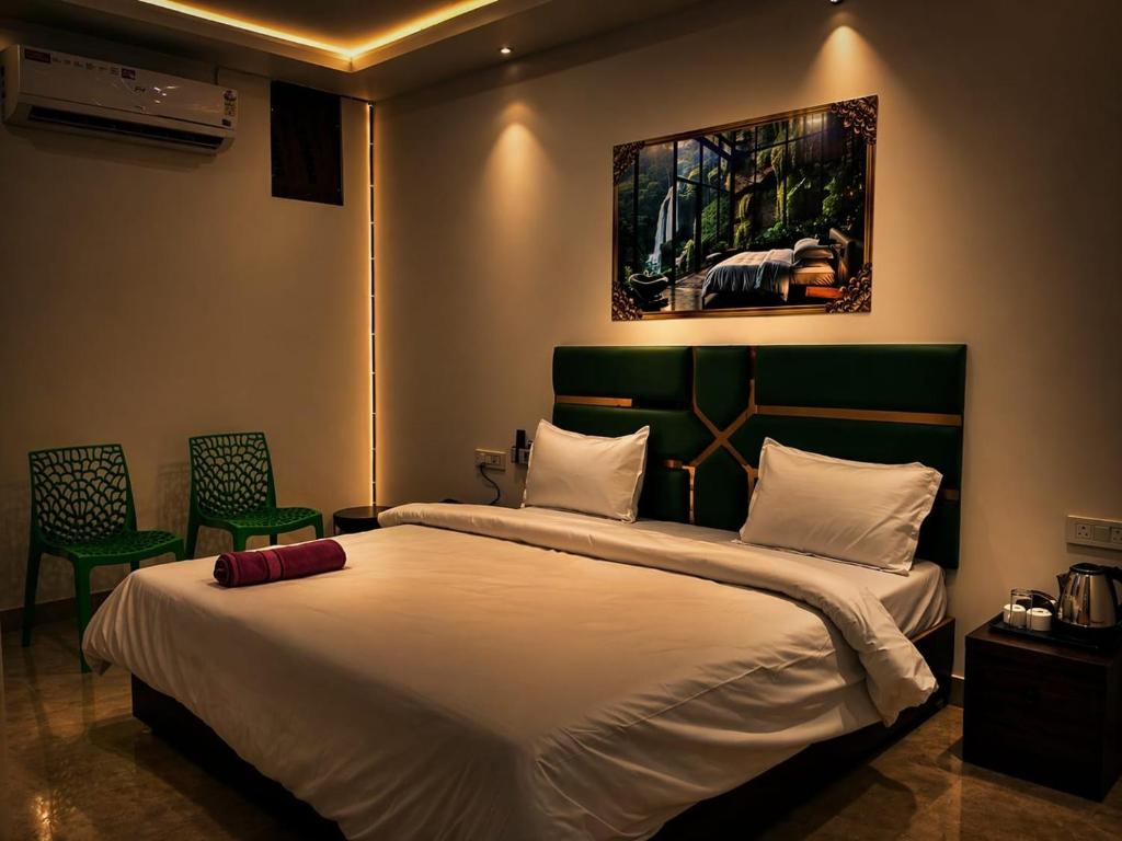 a bedroom with a large bed and two chairs at hotel tamanna in Lucknow