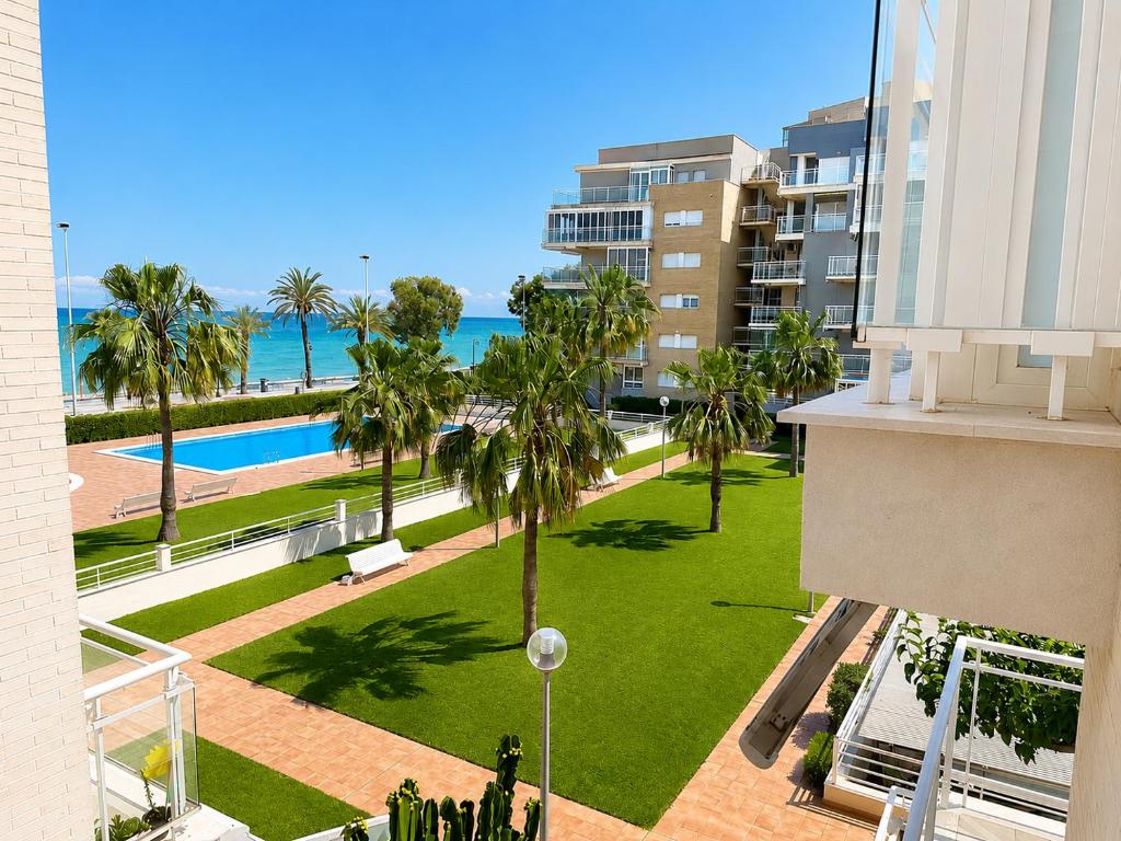 an aerial view of a park with palm trees and the ocean at Seaside Apartment Retreat in Benicàssim