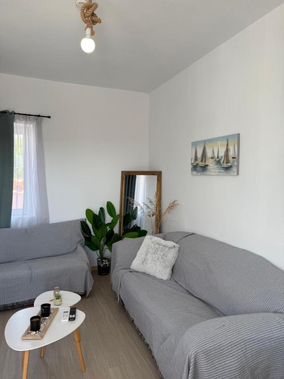 a living room with a couch and a table at Above the Sea - Sparto in Spartos