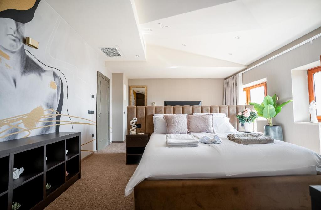 a bedroom with a large white bed with two pillows at Boutique Hotel Solterra - Crikvenica in Crikvenica