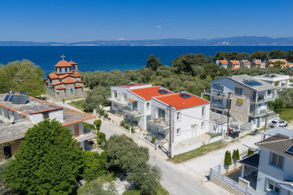 an aerial view of a house with a church at VILLA TOSTi & VILLA JOY in Skala Rachoniou