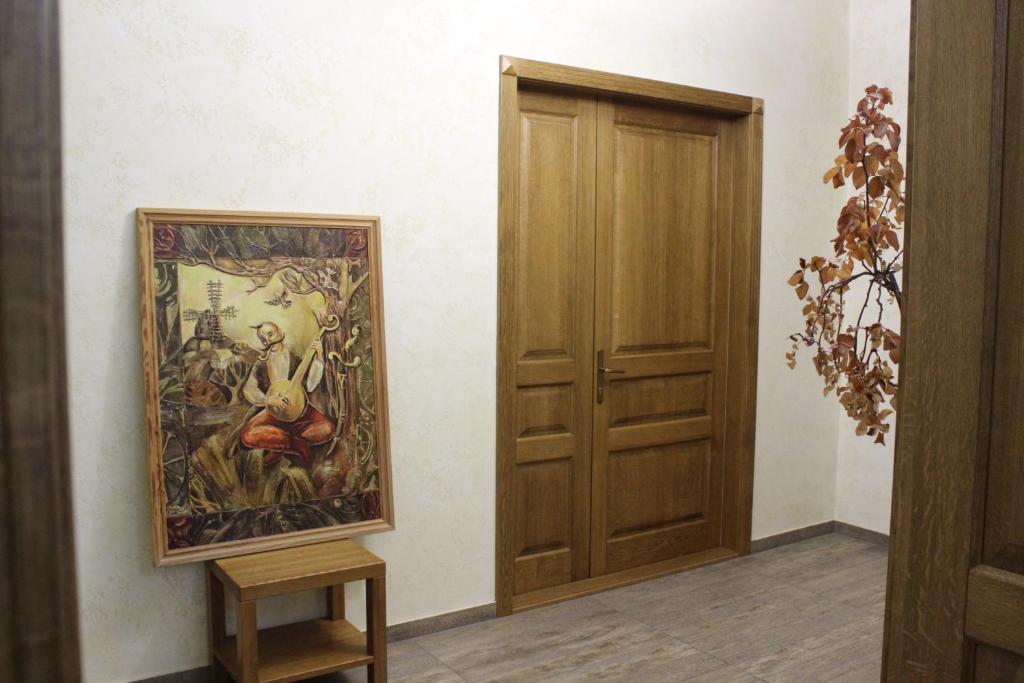 a painting on a wall next to a door at Strong Five apartment in Sumy