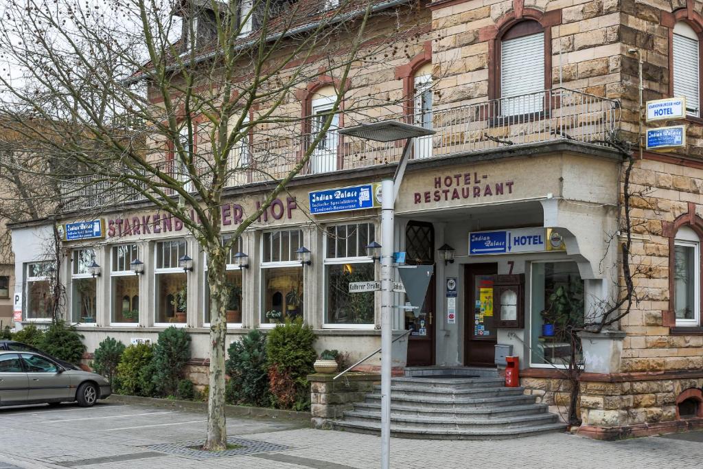 a building with a hotel restaurant on a street at Hotel Starkenburger Hof in Heppenheim an der Bergstrasse