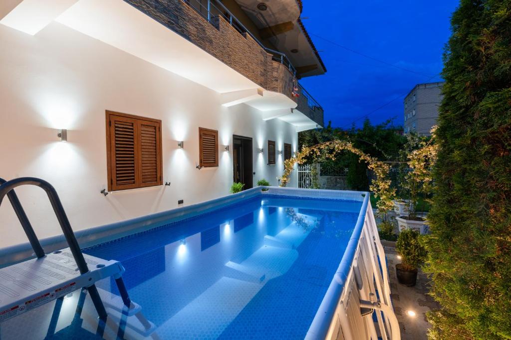 a swimming pool in front of a house at night at Swimming Pool - Marko Studios Berat in Berat