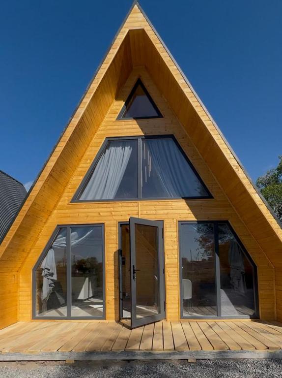 a house with glass doors and a pitched roof at Tosor Medet A-frame in Tossor