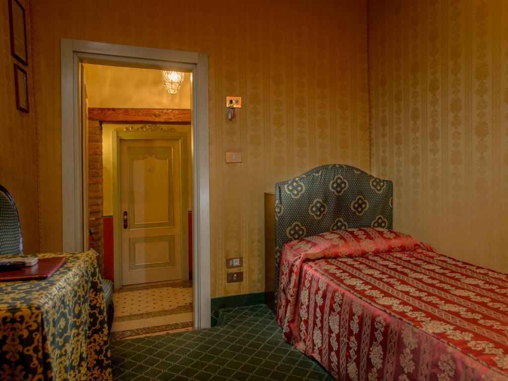 Postel nebo postele na pokoji v ubytování Centauro Hotel