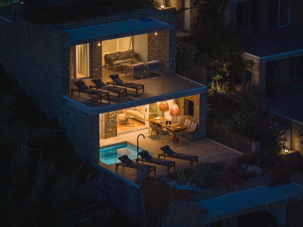 a house with a swimming pool at night at Villa Ammos with Private Pool, Sauna & Seaview in Gialova