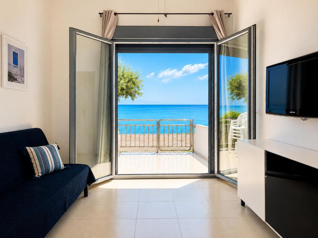 a living room with a view of the ocean at Beachfront Paradise in Leptokarya