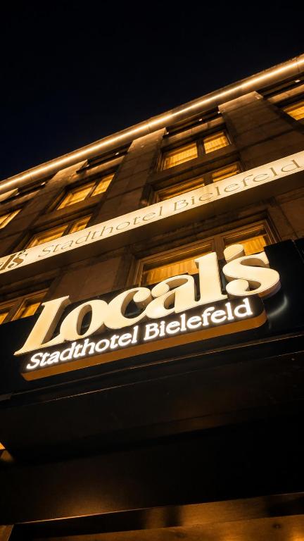 a sign on the side of a building at Locals Stadthotel Bielefeld in Bielefeld