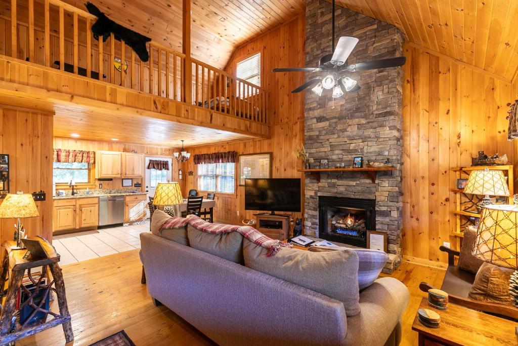 a living room with a couch and a fireplace at A Bears Hill in Boone