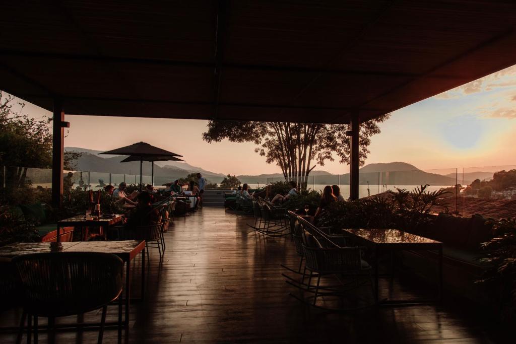 a group of people sitting at tables in a restaurant at Cinco Rodavento in Valle de Bravo