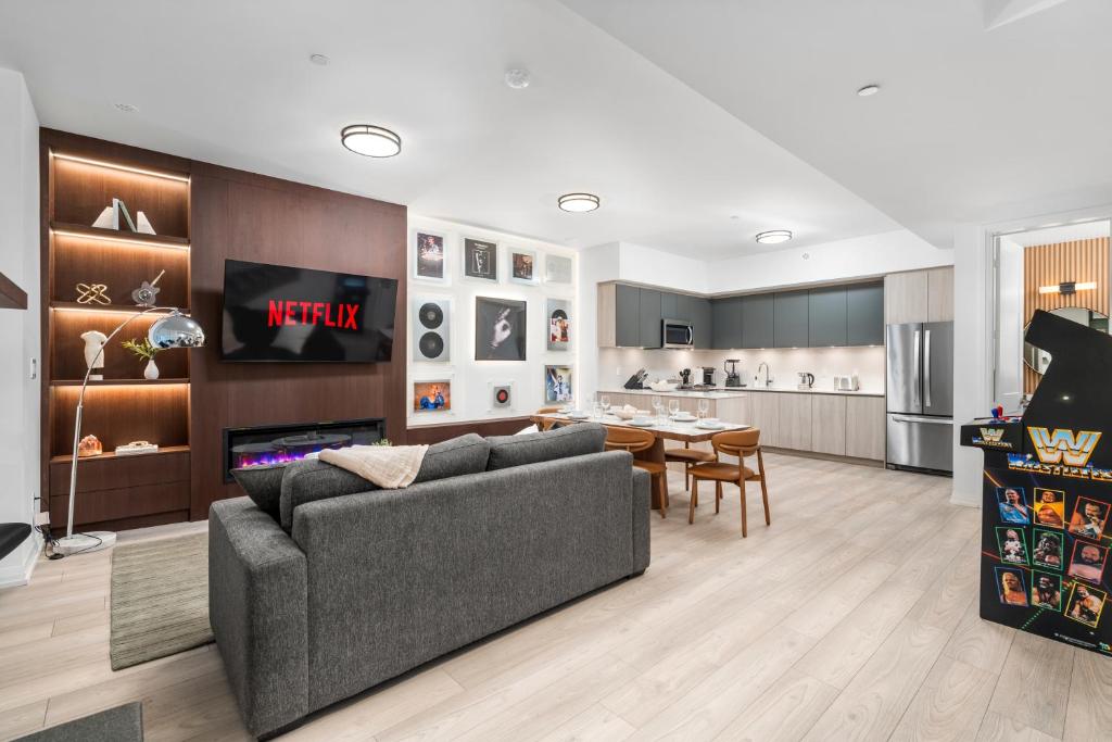 a living room with a couch and a dining room at Widmr Residences in Toronto