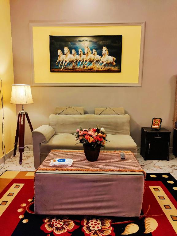 a living room with a couch and a table at MosesVilla in Jabalpur