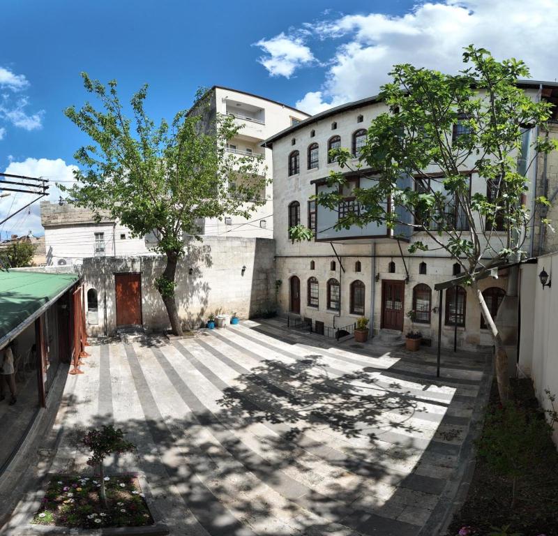 an old building with trees in front of it at Gaziayintap Konağı in Şahinbey