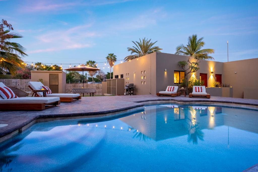 a swimming pool in front of a house at Hotel Hondo in Los Barriles