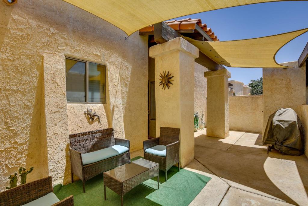 a patio with chairs and a couch on a building at Remote Work Ready! Central Yuma Condo w/ Patio in Yuma