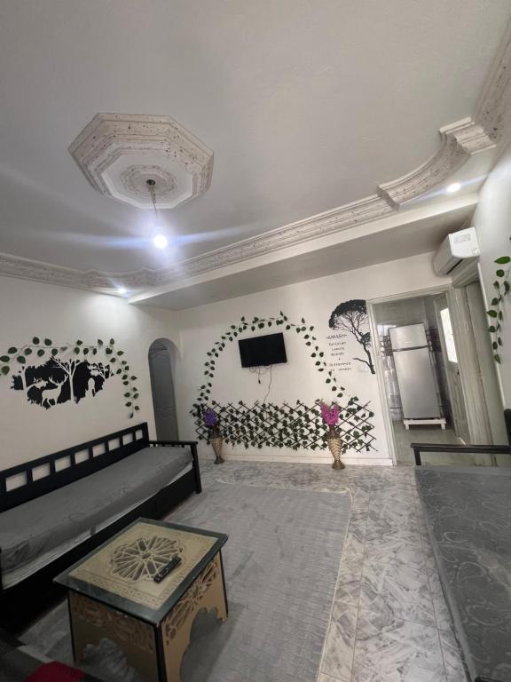 a living room with a couch and a tv on the wall at Djerba Appartement in Houmt Souk