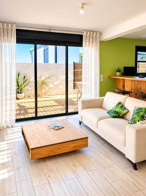a living room with a couch and a table at Villa des trois singes in Saint-Pierre