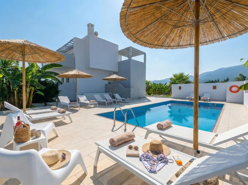 an image of a villa with a swimming pool and umbrellas at Lilu Villa 2 with Private Pool and Seaview in Tigaki