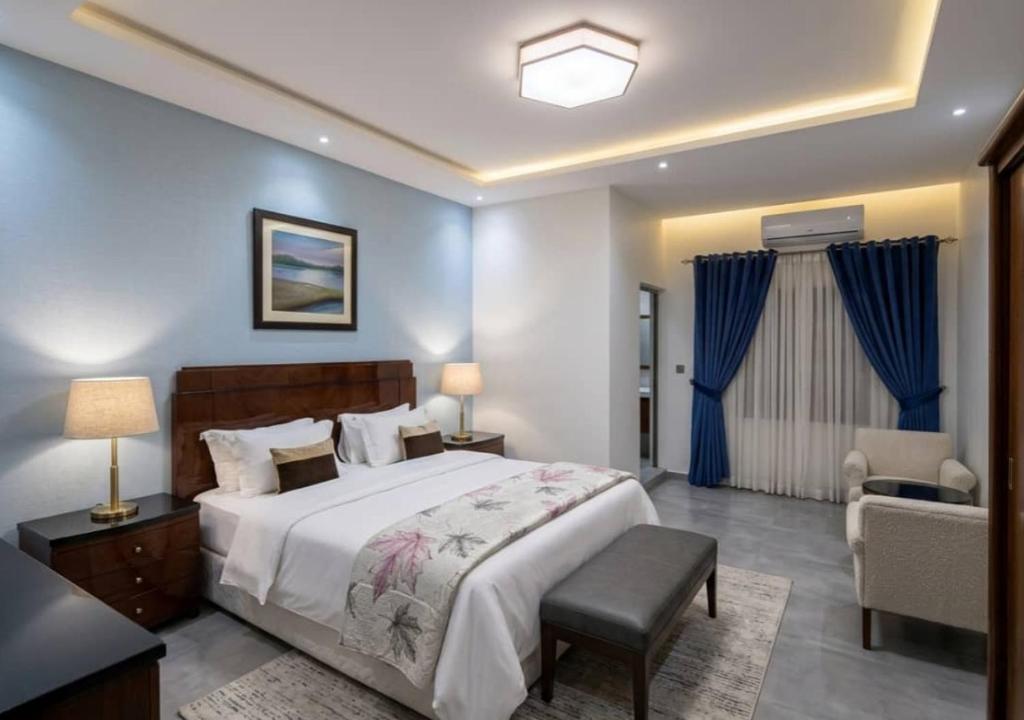a bedroom with a large bed with blue walls at Amsy hotel in Dakar