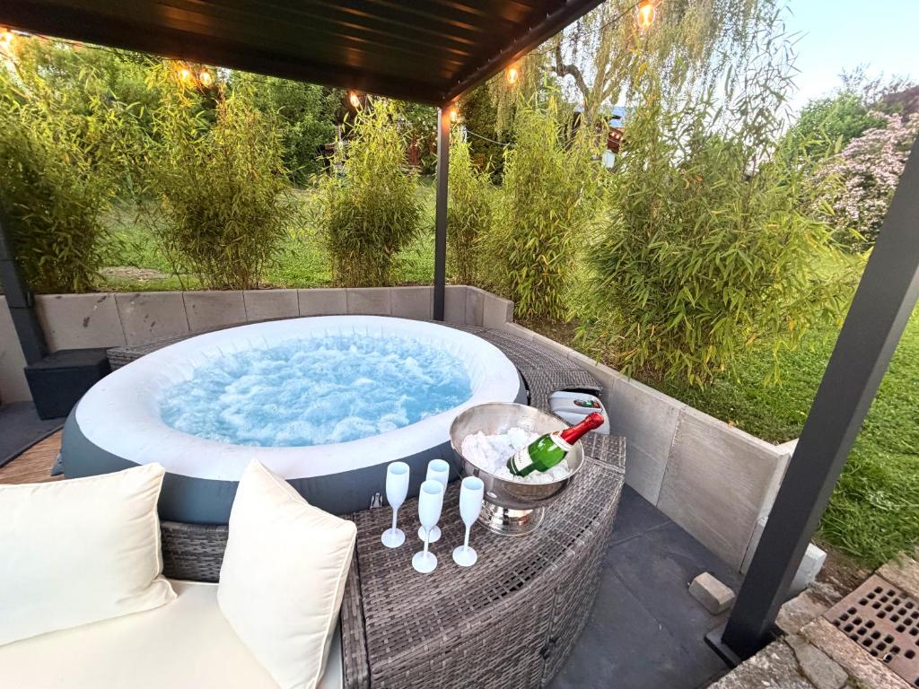 a jacuzzi tub sitting on top of a patio at Ferienhaus mit Whirlpool, Garten und großer Terrasse ruhig privat in Herbstein