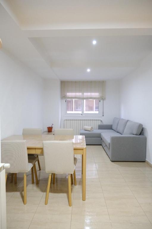 a living room with a table and a couch at Apartament Esmolet in La Pobla de Segur
