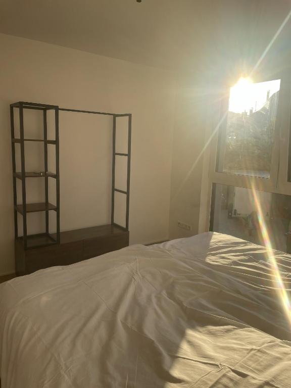 a bedroom with a white bed and a window at M&S Apartments - Self Checkin in Degerfelden
