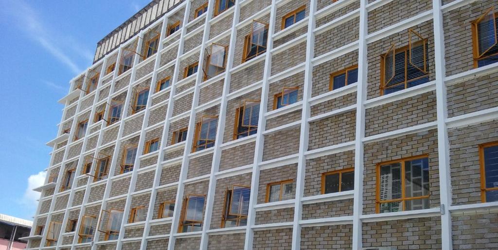 a tall brick building with many windows on it at Rittoo Complex -Gavnor in Quatre Bornes