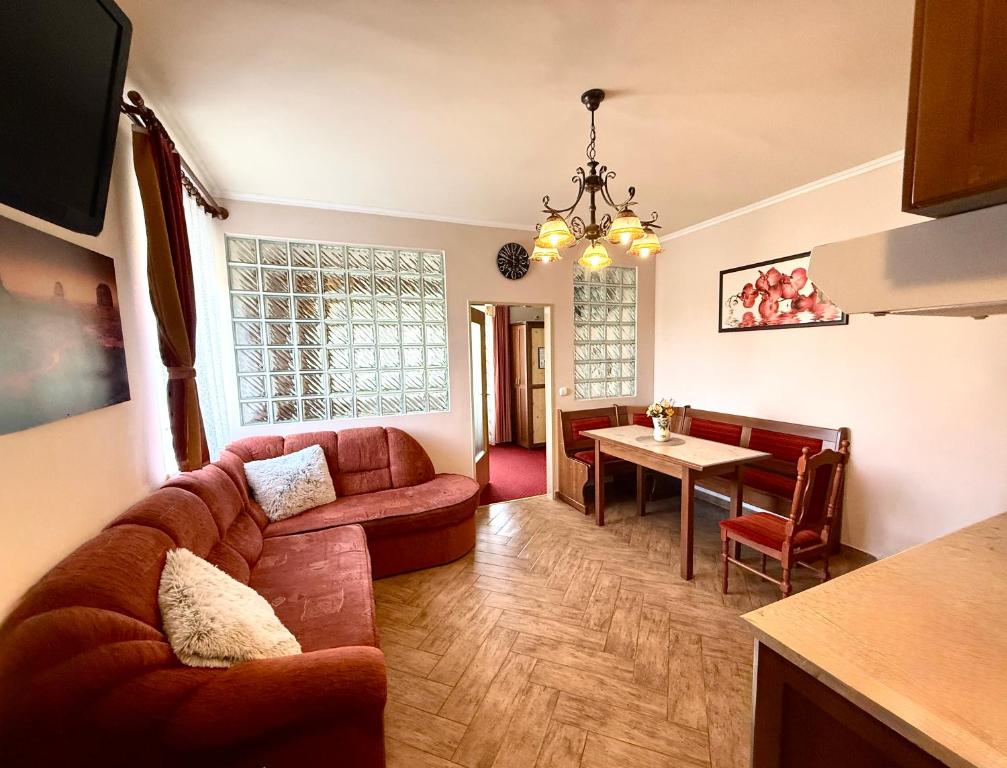 a living room with a couch and a table at HoldLux Green Keyless 0-24 Apartman in Sárvár