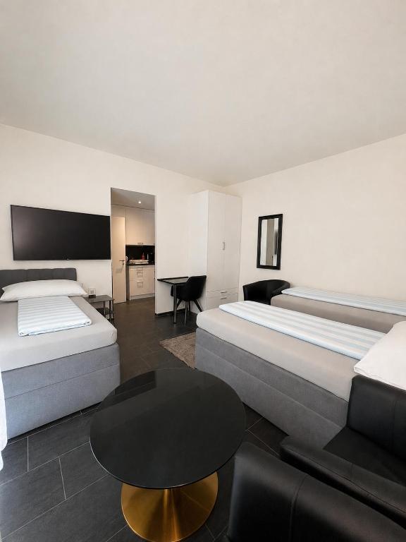 a hotel room with two beds and a table at Seefeld Residenz in Zurich