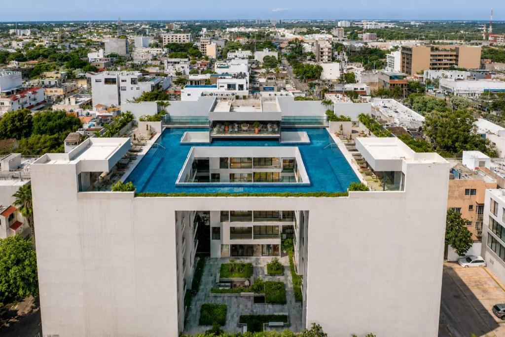an aerial view of a building with a swimming pool at Ceiba 25 by Andiani Travel in Playa del Carmen