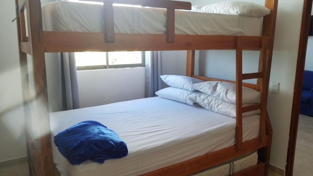 a couple of bunk beds with pillows on them at Apartamentos en coveñas in Coveñas