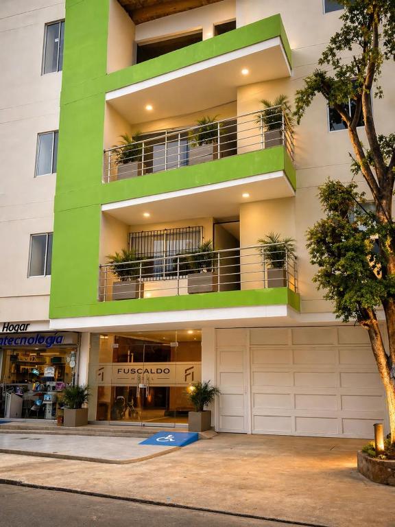 an apartment building with balconies and plants at Fuscaldo Hotel in Valledupar