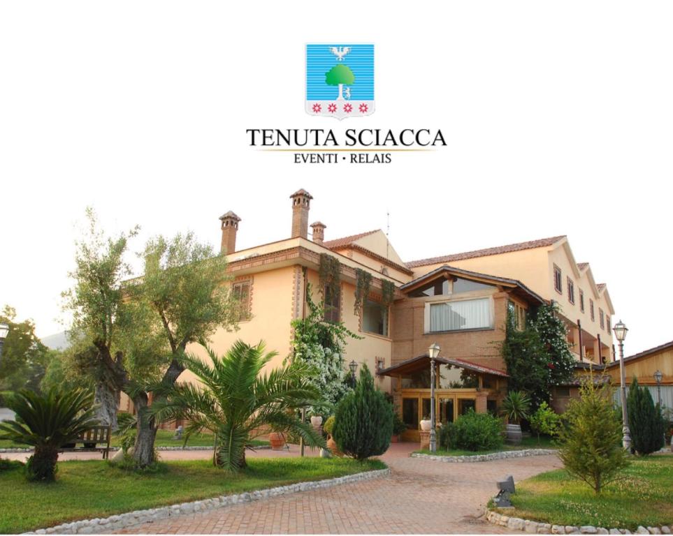 a villa in a resort with trees in front of it at Tenuta Sciacca in Falciano del Massico