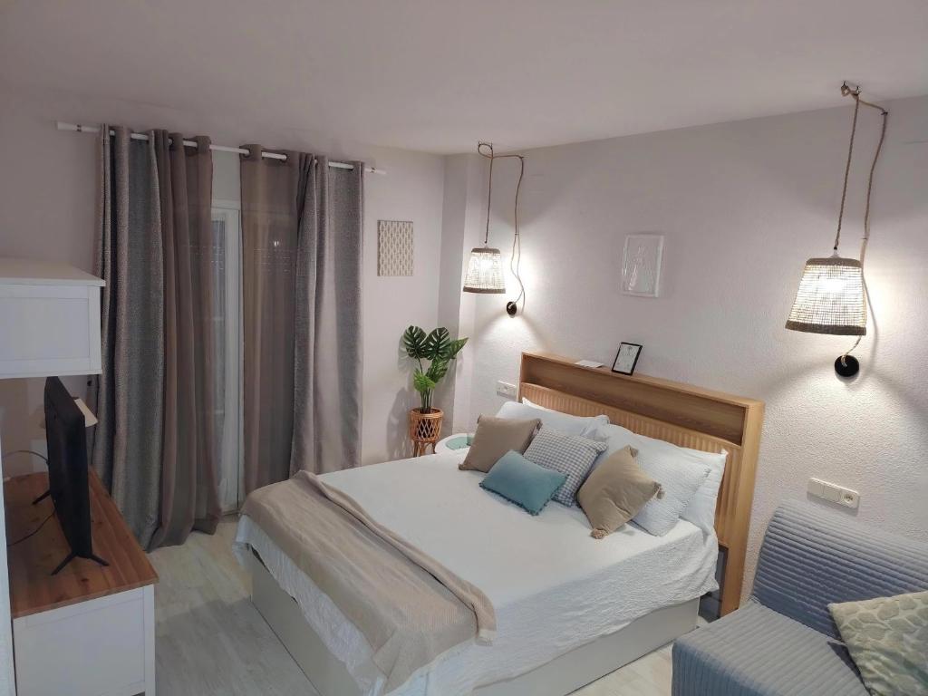 a bedroom with a bed and a tv in it at LolaSuite Confort in El Rocío