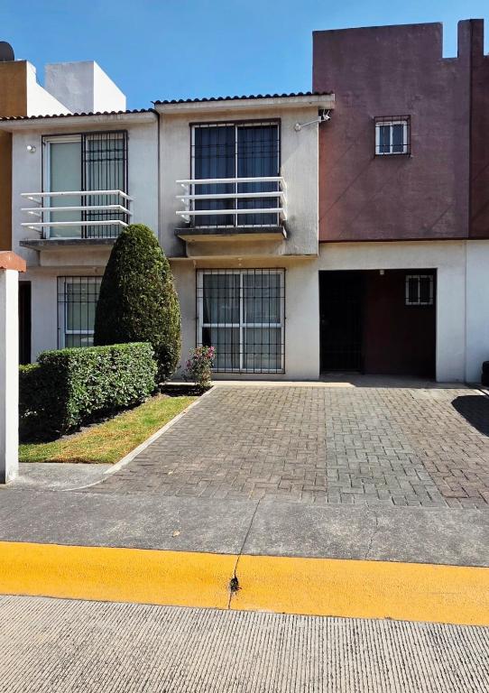 a house with a yellow curb in front of a driveway at Casa Misiones 1 in El Espino