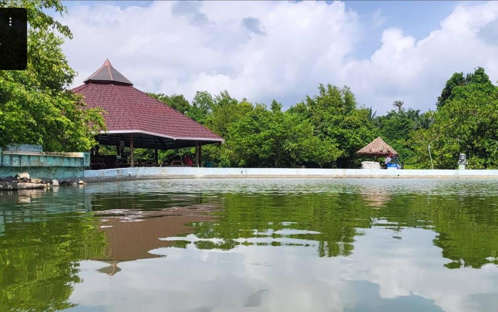 a large pond with a gazebo in a park at Green Palm Resort Lekki in Ikuata