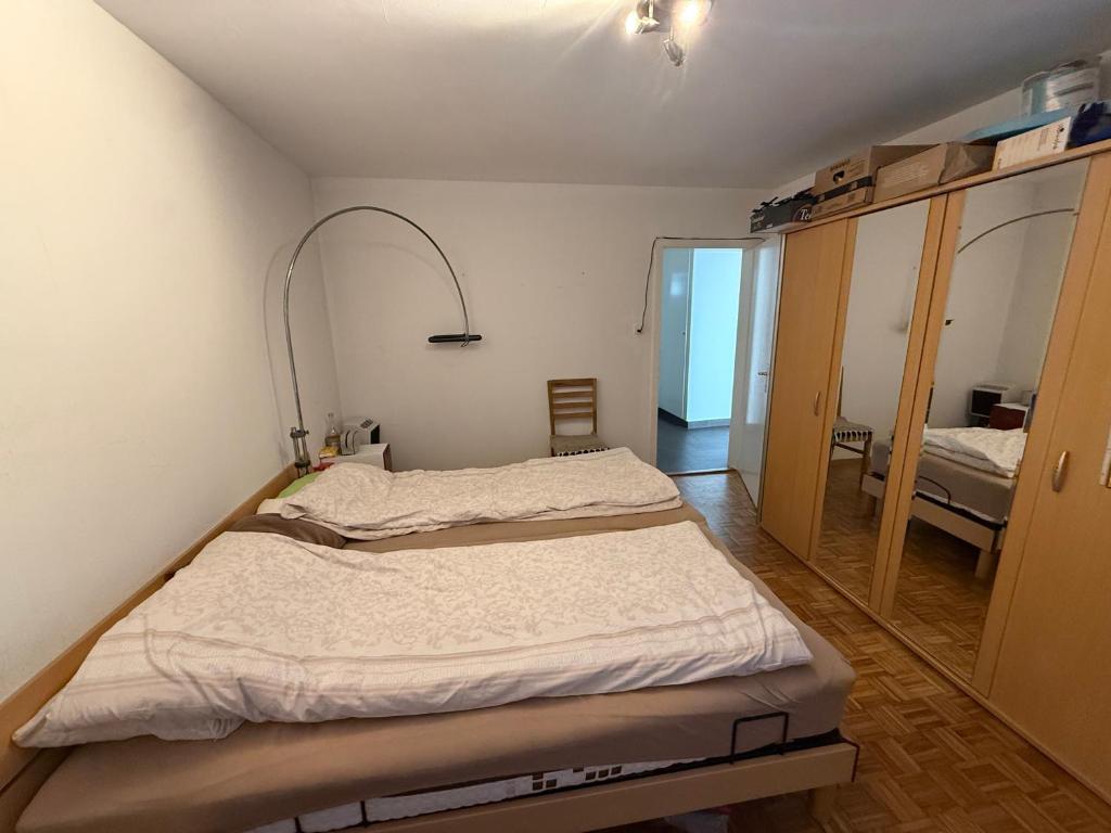 a hospital room with a bed and a mirror at Cosy Place in Monthey