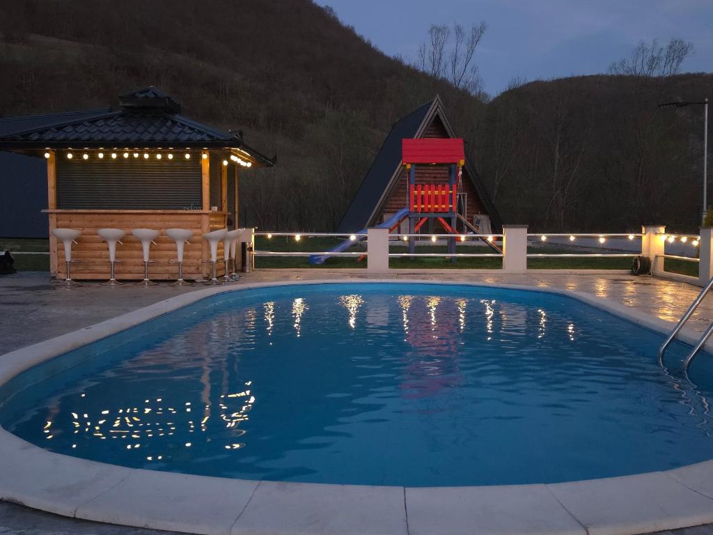 a swimming pool at night with a playground at Etno Selo Relax in Šipovo