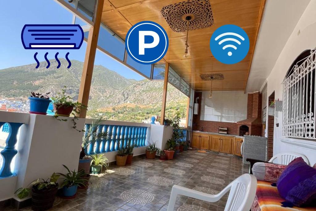 a room with a balcony with a view of a mountain at Dar RADI Appart Terrace in Chefchaouen