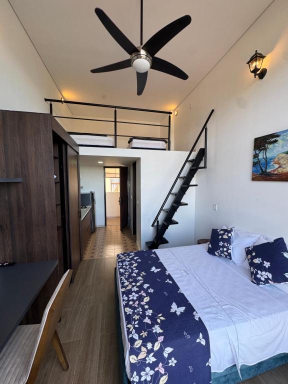 a bedroom with a bed with a ceiling fan at VILLA DEL ROSARIO in Tena