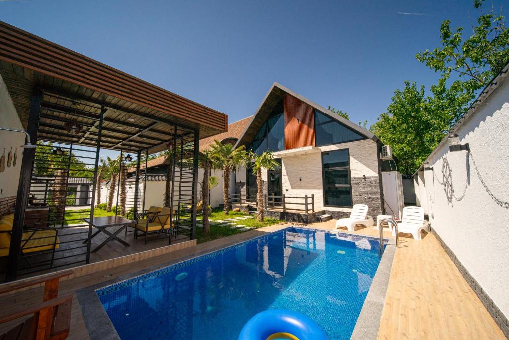 a swimming pool in the backyard of a house at Qafqaz Retro Bungalow in Gabala
