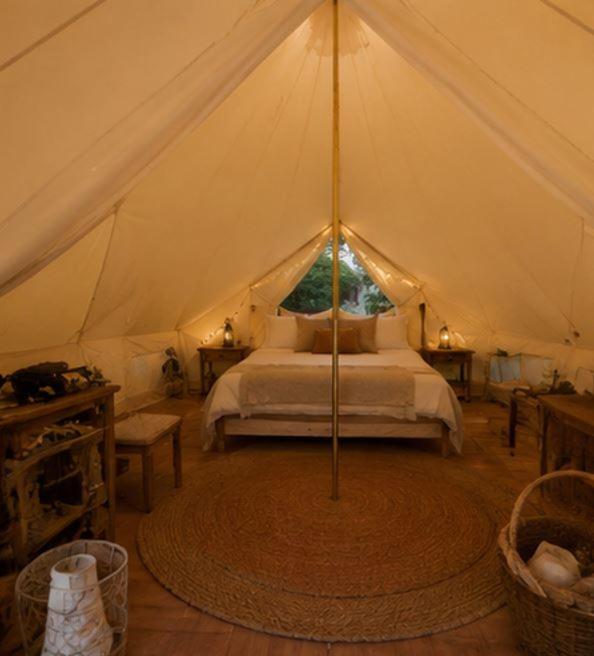 a bedroom with a bed in a tent at Near The City Tent in Sainte-Catherine